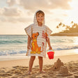Boy wearing a Lion King Simba hooded poncho towel on the sand – Jack Gifts Online Lebanon