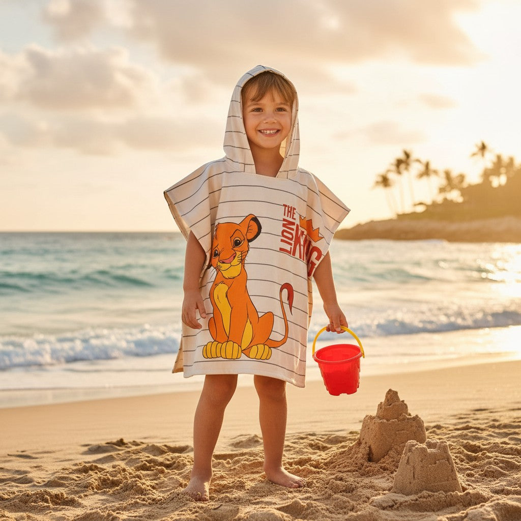 Boy wearing a Lion King Simba hooded poncho towel on the sand – Jack Gifts Online Lebanon