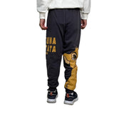 Back view of charcoal grey kids joggers with Hakuna Matata text and a lion cub leg print