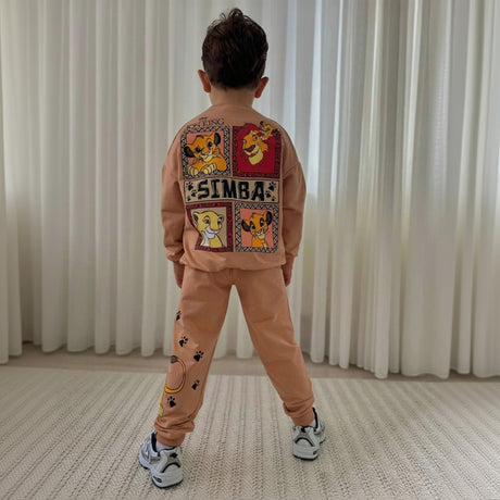 Back of a kids tan sweatshirt showing a four panel Simba print with paw prints on the joggers