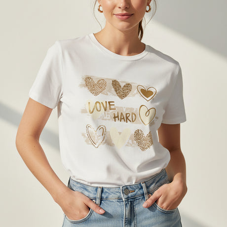 Woman wearing white tshirt with decorative heart designs 