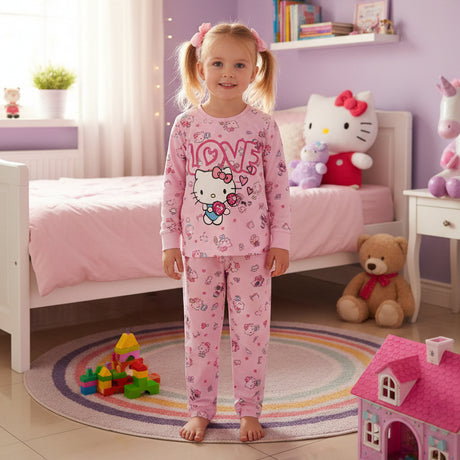 Kid wearing a pink Hello Kitty pajama in a bedroom setting