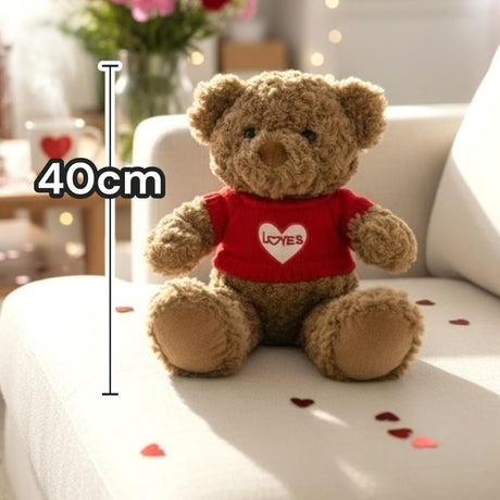 Golden brown bear in the red heart jumper surrounded by foil heart confetti
