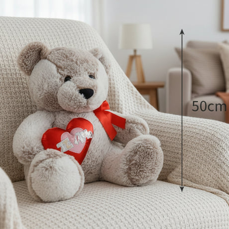 Taupe teddy bear in a red satin bow holding a padded red heart, with a 50cm line