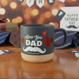 Gray mug with 'Love You Dad' text on a wooden surface