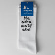 White crew socks reading 'Ma adra wa2if akel' in bold text