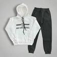 White hoodie with a football badge print laid out with charcoal joggers