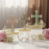 Pink, grey and mint pearlised crosses on clear blocks among peonies and roses