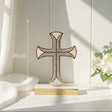 Ivory mother of pearl cross against a white panelled wall with hydrangea