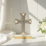 Ivory mother of pearl cross against a white panelled wall with hydrangea