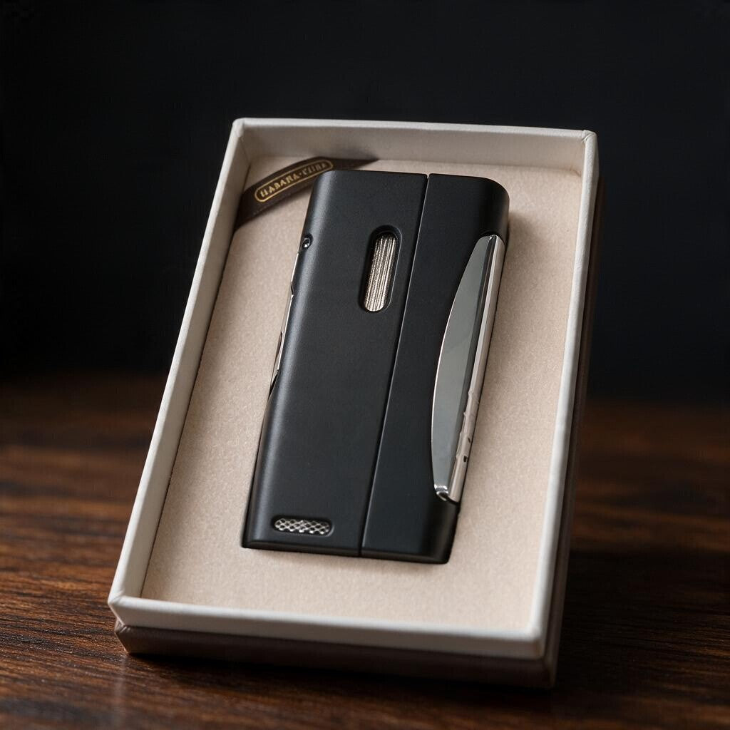 Back of a matte black cigar lighter with a ribbed fuel window and chrome side blade in a cream box