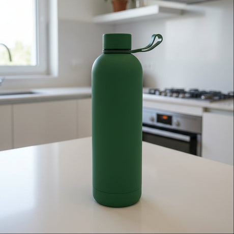 Forest green matte insulated bottle with a silicone carry loop in a kitchen