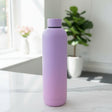 Lilac to pink matte 750ml insulated bottle on a marble counter with roses