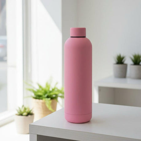 Dusty pink matte 750ml insulated bottle beside small succulents
