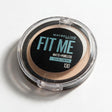 Maybelline Fit Me Matte Poreless pressed powder in shade 130, a compact on a white surface with a soft shadow