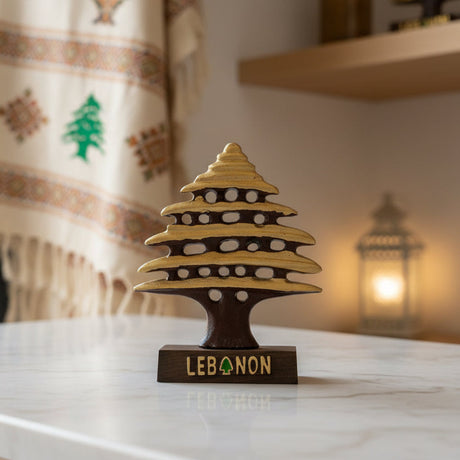 Gold and brown cedar tree statue with pierced branch tiers on a wooden Lebanon base