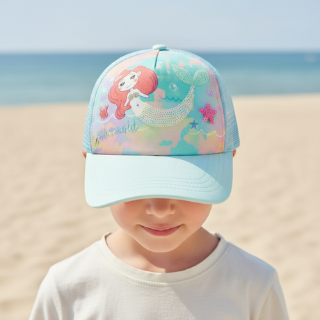 Child wearing a pastel blue kids cap with a sequin mermaid, whale tail and starfish design