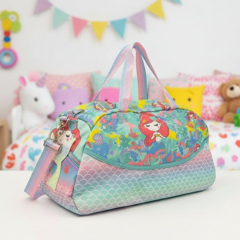 Aqua mermaid duffle bag with a rainbow shoulder strap, pastel scale base and zipped top