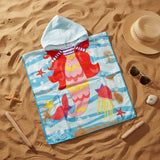 Aqua striped mermaid poncho towel with a jellyfish and starfish print flat lay on sand