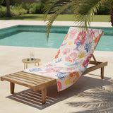 Mermaid and jellyfish print towel draped over a wooden lounger beside a pool