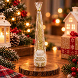 Gold glitter gnome ornament with a white beard and Merry Christmas lettering on a wood slice