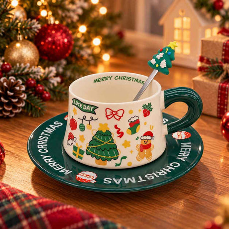 White Christmas teacup with gingerbread and tree prints on a dark green Merry Christmas saucer