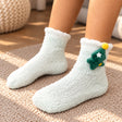 Mint fuzzy kids socks with a white cuff and a plush green Christmas tree on the ankle
