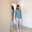 Pale printed pyjama bottoms worn with a soft aqua top and fluffy slippers