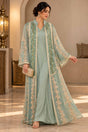 Woman in a mint two piece abaya with a sheer embroidered open robe over a matching maxi dress