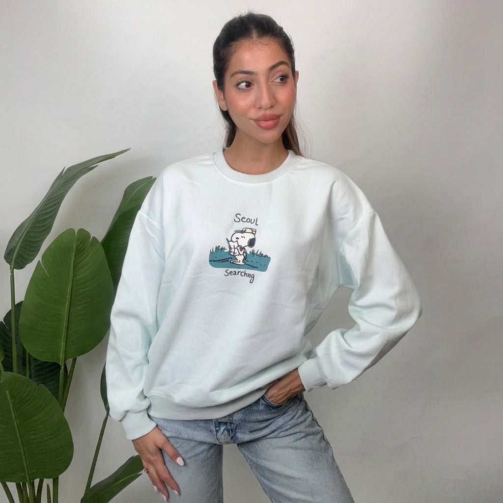 Mint puppy scout sweatshirt shown with one hand on hip and relaxed dropped shoulders