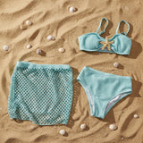 Mint starfish bikini top and bottom flat lay on sand