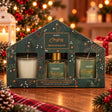 Three Mistletoe and Fir scented candles in a green and gold house shaped Christmas gift box