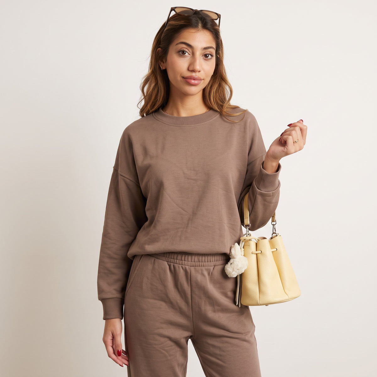 Close view of the mocha sweatshirt ribbed crew neckline and elastic waist sweatpants