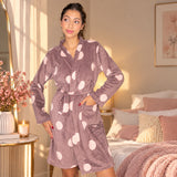 Mocha brown dressing gown with pink polka dots worn with a hand on the hip