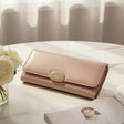 Soft toned women's wallet with an elegant gold clasp