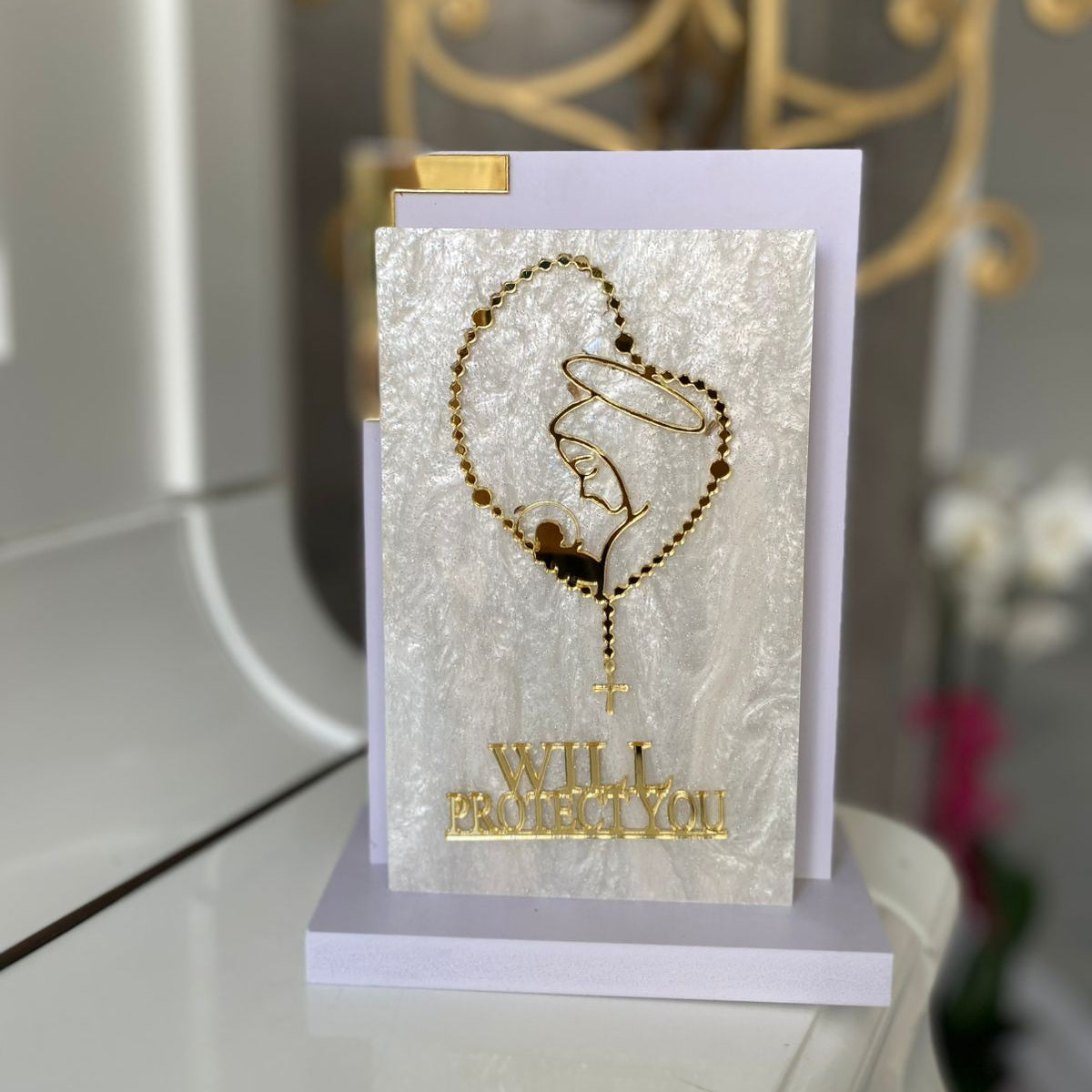 Single line gold outline of the veiled Virgin ringed by a rosary, Will Protect You