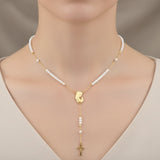 Pearl Mother Mary necklace with a gold cross worn by a woman
