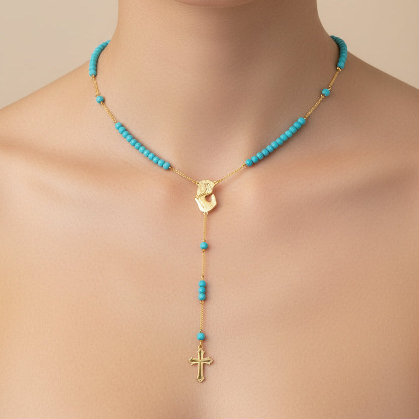 Mother Mary necklace with turquoise beads and gold accents on a neutral background