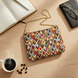 Diamond weave tapestry bag laid on a desk beside a coffee cup