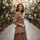 Multicolor tapestry crossbody bag worn on a cobbled street