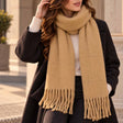 Warm mustard blanket scarf looped at the neck with long twisted tassels