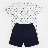 White sailboat and anchor print tee with navy shorts laid flat
