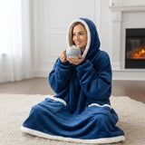 Kneeling by a lit fireplace with hot chocolate, in navy with ivory sherpa edging the hood and hem