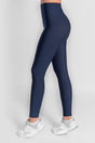 Navy leggings worn by a person on a white background