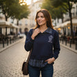 Woman wearing a navy check collar sweatshirt on a cobbled street