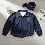 Navy sweatshirt with a check collar and shirt hem beside a matching scarf