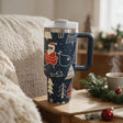 Navy insulated tumbler with a handle, printed with Santa and snowy Christmas trees