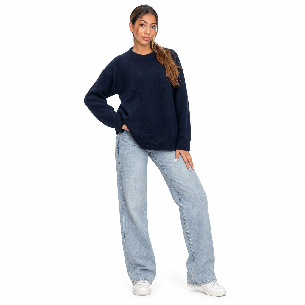 Navy blue wool knit crew neck sweater with light jeans and white sneakers