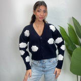 Navy V neck cardigan with white cloud patches on the body and sleeves, worn with light jeans