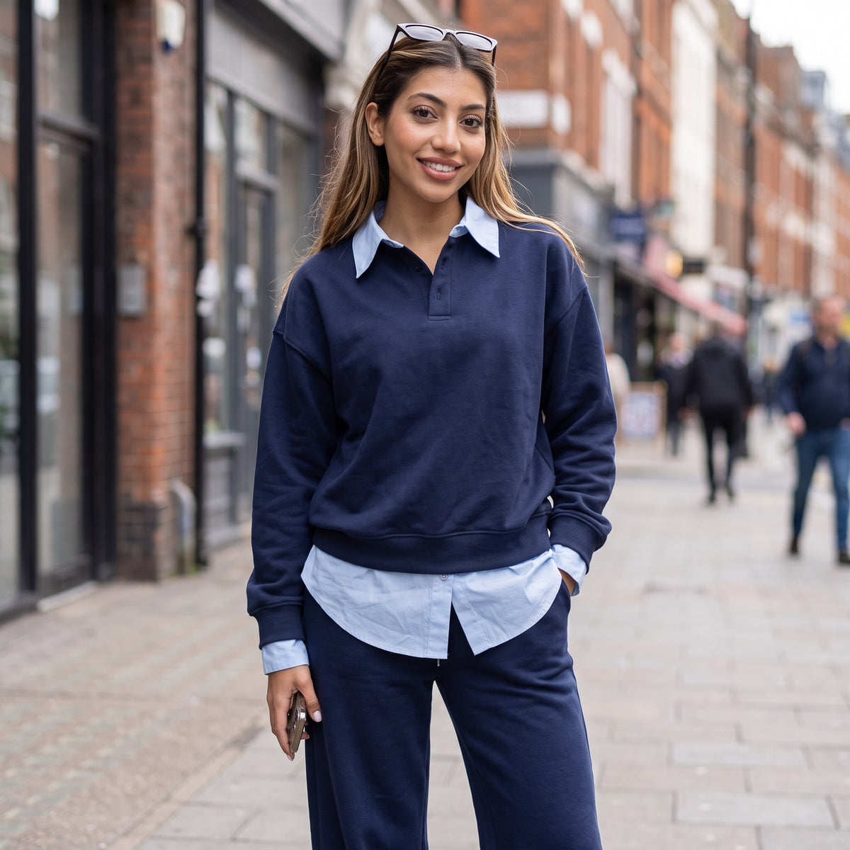 Navy lounge set styled with sunglasses pushed up and one hand in the pocket